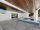 Covered patio with outdoor kitchen and spa at 598 Lyons Ln, Longboat Key, FL 34228