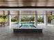 Covered patio with built in spa overlooking the pool at 598 Lyons Ln, Longboat Key, FL 34228