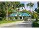 Gated community entrance with palm trees and a guardhouse at 6615 Hunter Combe Xing, University Park, FL 34201