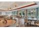 Bright dining room with multiple tables and large windows at 6615 Hunter Combe Xing, University Park, FL 34201
