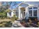 Landscaped walkway leads to the home's front entrance, featuring arched entryway at 6615 Hunter Combe Xing, University Park, FL 34201