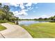 Landscaped golf course with a serene lake and walking path at 6615 Hunter Combe Xing, University Park, FL 34201