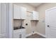 Laundry room with cabinets, sink, and overhead storage at 6615 Hunter Combe Xing, University Park, FL 34201