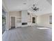 Spacious living room featuring a modern fireplace and built-in shelving at 6615 Hunter Combe Xing, University Park, FL 34201