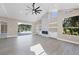 Spacious living room featuring a fireplace and access to the pool at 6615 Hunter Combe Xing, University Park, FL 34201