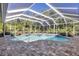 Relaxing kidney-shaped pool with screened enclosure and paver deck at 6615 Hunter Combe Xing, University Park, FL 34201