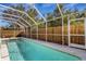 Inviting screened pool with wooden fence and plenty of space for relaxation at 7820 Ontario Street Cir, Sarasota, FL 34243