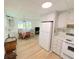 View of kitchen with white cabinets, a refrigerator, and a dining area at 11200 Walsingham Rd # 66, Largo, FL 33778