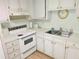 White cabinets and appliances in this updated kitchen at 11200 Walsingham Rd # 66, Largo, FL 33778