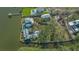 Aerial view of estate-sized home with expansive lot, surrounded by water and mature trees at 1249 S Basin Ln, Sarasota, FL 34242