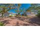 Expansive two-story home with a circular brick driveway, mature trees, and an attached three-car garage at 1249 S Basin Ln, Sarasota, FL 34242