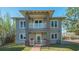 Two-story gray house with a balcony and brick walkway at 1249 S Basin Ln, Sarasota, FL 34242