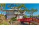 Gray house with three-car garage and a red footbridge at 1249 S Basin Ln, Sarasota, FL 34242