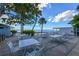 Outdoor patio with tables and chairs, palm trees, and a stunning view of the ocean at 1249 S Basin Ln, Sarasota, FL 34242