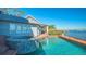 Inviting waterfront pool and spa with brick accents, complemented by tranquil water views at 1249 S Basin Ln, Sarasota, FL 34242