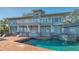 Beautiful backyard pool area with a jacuzzi, brick surround, and spacious balcony overlooking the water at 1249 S Basin Ln, Sarasota, FL 34242