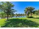 Serene backyard with pond views and mature trees at 16920 Pelham Pl, Bradenton, FL 34202