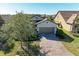 House exterior with a brown garage door and landscaping at 16920 Pelham Pl, Bradenton, FL 34202