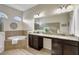 Elegant bathroom with double sinks, granite countertops, and large mirror at 17113 1St E Dr, Bradenton, FL 34212