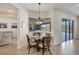 Breakfast nook with a glass-top table and four chairs, overlooking the pool at 17113 1St E Dr, Bradenton, FL 34212