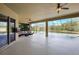 Covered patio with seating area overlooking the pool and pond at 17113 1St E Dr, Bradenton, FL 34212