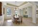 Formal dining room with a rustic wood table and six chairs, near the entryway at 17113 1St E Dr, Bradenton, FL 34212