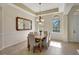 Bright dining room with wood table, chandelier, and large mirror at 17113 1St E Dr, Bradenton, FL 34212