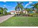Spanish style home with red door, paver driveway & lush landscaping at 17113 1St E Dr, Bradenton, FL 34212