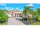 One-story home with tile roof, palm trees, and landscaped yard at 17113 1St E Dr, Bradenton, FL 34212