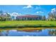 House back view with large screened patio overlooking the lake at 17113 1St E Dr, Bradenton, FL 34212