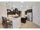 Modern kitchen with dark cabinetry, granite counters, and island with seating at 17113 1St E Dr, Bradenton, FL 34212
