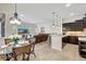 Open kitchen with dark cabinetry, granite island, and stainless steel appliances at 17113 1St E Dr, Bradenton, FL 34212