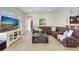 Spacious living room with sectional sofa and large TV at 17113 1St E Dr, Bradenton, FL 34212