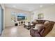 Spacious living room with brown sectional sofa and large TV at 17113 1St E Dr, Bradenton, FL 34212