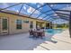 Covered patio with seating area adjacent to the pool and house at 17113 1St E Dr, Bradenton, FL 34212
