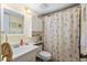 Clean bathroom with seashell shower curtain and vanity at 1720 Glenhouse Dr # 330, Sarasota, FL 34231