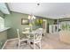Bright dining area with a glass-top table and white chairs at 1720 Glenhouse Dr # 330, Sarasota, FL 34231