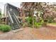 Exterior view of the condo with a wooden staircase and lush landscaping at 1720 Glenhouse Dr # 330, Sarasota, FL 34231