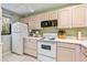 Efficient kitchen with ample cabinetry and a microwave at 1720 Glenhouse Dr # 330, Sarasota, FL 34231