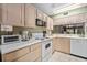 Bright kitchen features white appliances and ample cabinetry at 1720 Glenhouse Dr # 330, Sarasota, FL 34231