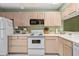 Well-equipped kitchen with light wood cabinets and white appliances at 1720 Glenhouse Dr # 330, Sarasota, FL 34231