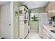 Kitchen with white cabinets, appliances, and access door at 1720 Glenhouse Dr # 330, Sarasota, FL 34231