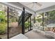 Bright sunroom with wicker furniture and view of the garden at 1720 Glenhouse Dr # 330, Sarasota, FL 34231