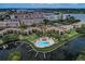 Aerial view showing community pool, boat docks, and lush landscaping at 1800 Cove Ii Pl # 213, Sarasota, FL 34242