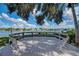 Elevated wooden deck with benches offering scenic waterfront views at 1800 Cove Ii Pl # 213, Sarasota, FL 34242