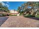 Brick-paved parking area with covered carport at 1800 Cove Ii Pl # 213, Sarasota, FL 34242