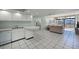 Kitchen with white cabinets, a breakfast bar, and appliances at 1945 Gulf Of Mexico Dr # M2-206, Longboat Key, FL 34228