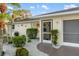 Front entry with screen door and landscaped walkway at 20207 Gladstone Ave, Port Charlotte, FL 33952