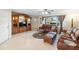 Living room featuring brown leather furniture and a large TV stand at 20207 Gladstone Ave, Port Charlotte, FL 33952