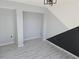 Well-lit bedroom with gray and black accent walls and new flooring at 21459 Olean Blvd, Port Charlotte, FL 33952